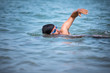 © lightpoet - Triathlete man swimming freestyle crawl in ocean - Male triathlon swimmer training for a triathlon