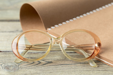 Wall Mural - notepad and eyeglasses on the table