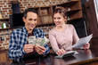 © LIGHTFIELD STUDIOS - portrait of happy couple counting money together at home