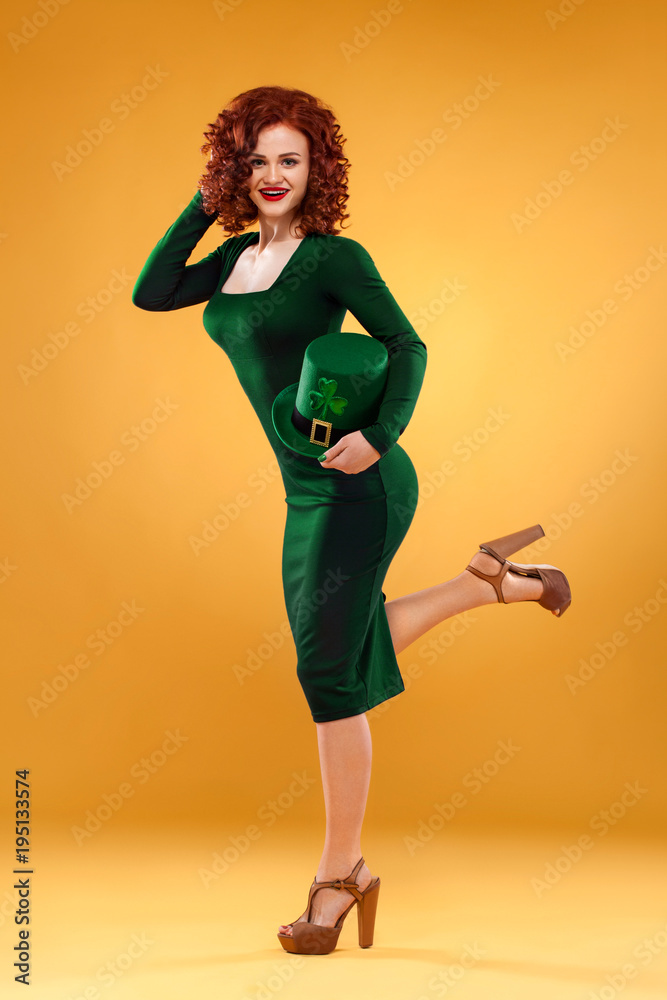 St Patrick Day. Beauty portrait of young ginger woman leprechaun, wearing green  dress and hat Stock Photo | Adobe Stock