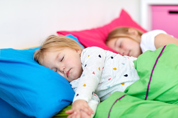 Poster - happy little girls sleeping in bed at home