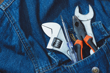 Jeans, repair equipment and many handy tools. Top view with copy space