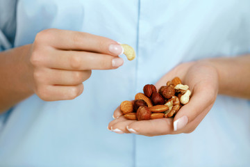 Wall Mural - Close Up Of Nuts In Woman Hands.