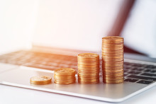 Stack Of Money Coins On Laptop Computer Background