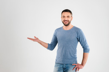 Wall Mural - Happy young man showing copyspace.