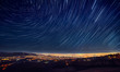 Night sky star trail over the city