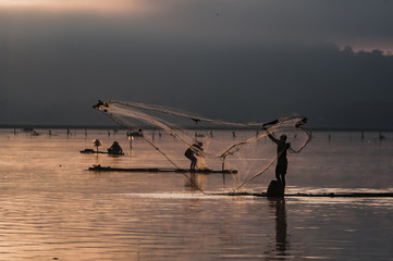 Wall Mural - Fisherman spreads the web in fishing morning, golden hours.