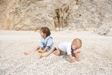 Wall Mural - Sister and Brother Playing with Stones