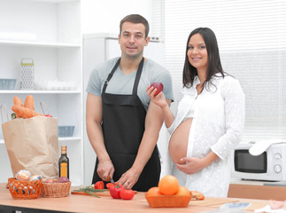 Wall Mural - happy husband makes Breakfast for his pregnant wife.