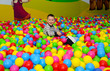 © Vadym - Child is playing in ball pit with colorful plastic balls in children entertainment center. Pool with bright balls background. Fun, game and play of a boy.