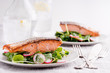 © Darren Muir/Stocksy - Roasted salmon fillets with spinach and radish salad.