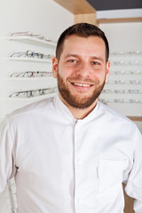 Wall Mural - Young ophthalmologist in optical store