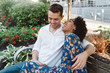 © Chelsea Victoria/Stocksy - A young couple sitting on a park bench listening to music