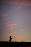 Fototapeta Kosmos - The Girl Flying Drone Sunset