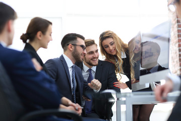 employees discussing financial charts