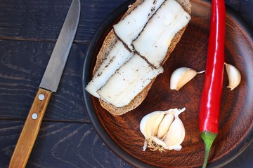 Poster - Sliced lard in a plate, garlic and red pepper