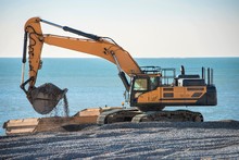 Construction Site - Engineering - Sea Defence. Large Plant Machinery Being Use To Build The Beach Sea Defence At Seaford, East Sussex, UK