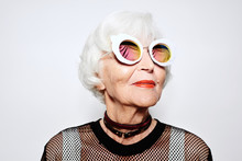 Smiling Senior Woman In Stylish Sunglasses And Shirt