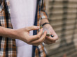 © Milles Studio/Stocksy - Man holding marijuana piece