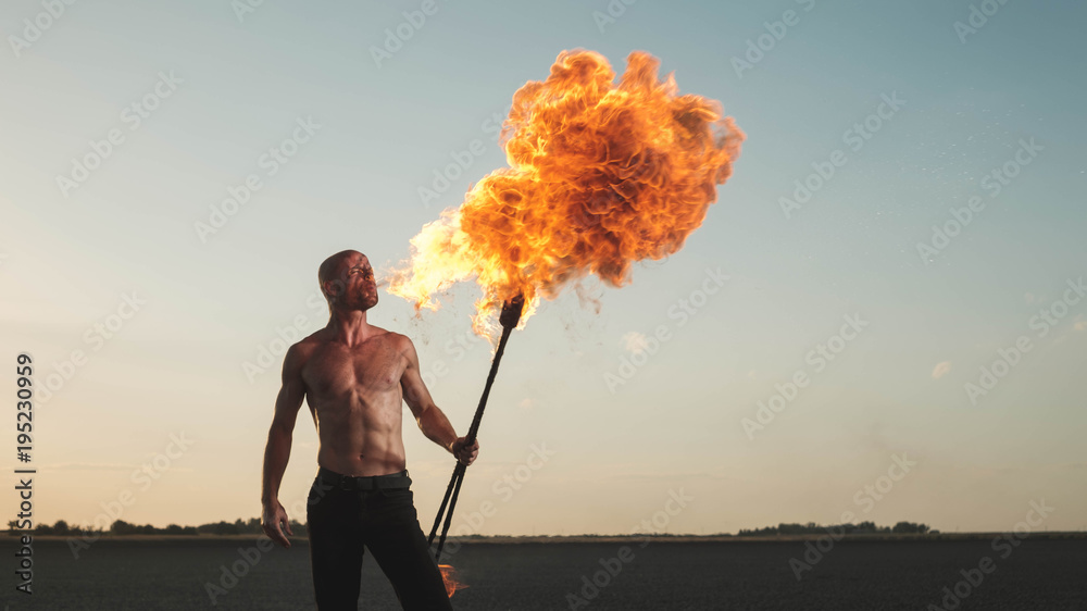 Acrobat Using Fire Male acrobat performing spitting fire act at the beach Stock Photo ...
