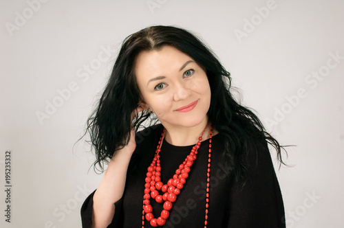 Fotografia A beautiful dark-haired woman touches her hair