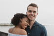 © Chelsea Victoria/Stocksy - A young couple posing for portraits by the water