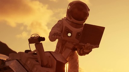 Wall Mural - astronaut in the space suit works on laptop, adjusting rover for mars further mars exploration.space