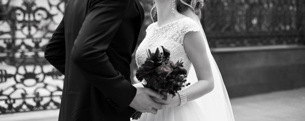 Wall Mural - Beautiful wedding bouquet of flowers in hands of the bride