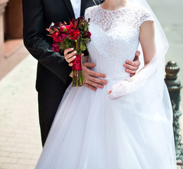 Canvas Print - Beautiful wedding bouquet of flowers in hands of the bride