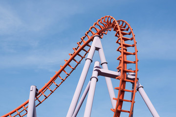 Roller coaster on blue sky background.