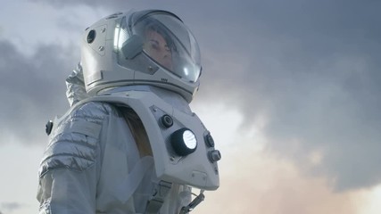 Wall Mural - female astronaut looking around alien planet. blue and cold planet.