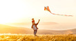 © JenkoAtaman - happy family father and child daughter run with  kite on meadow.