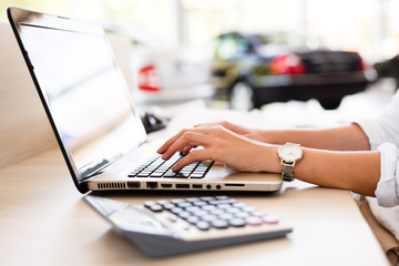 Car shop dealer working on financial documents