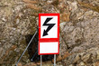 Warning sign high voltage, red and black on white background,  in nature in Sweden