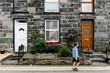 © LeaJones/Stocksy - boy walking by a house in britain