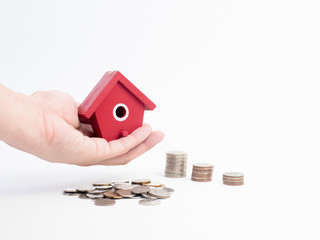 Wall Mural - Money coins stack growing with red house on wood background. Business growth investment and financial concept ideas.Real estate investment. House and coins on table.Save money with stack coin.