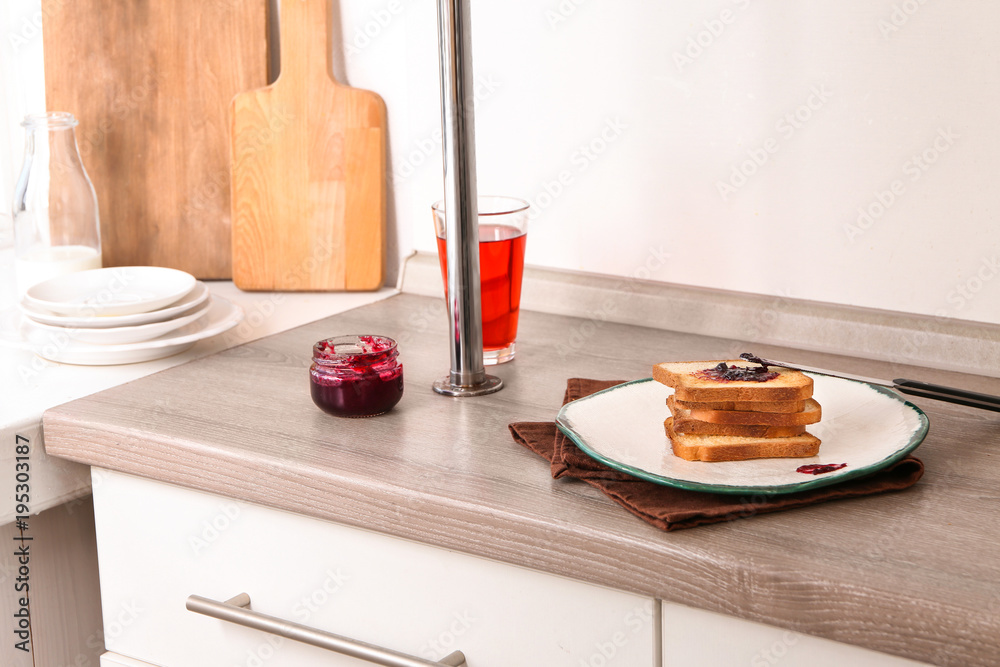 Plate with toasted bread and jam on table