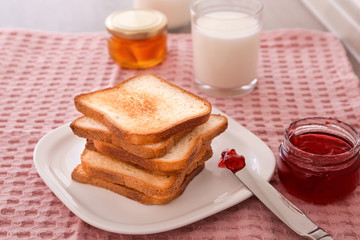 Canvas Print - Plate with toasted bread and jam on table