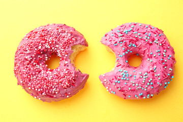 Sticker - Delicious pink donuts on color background