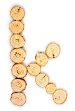 Alphabet letters made from Wood slice on white Background.k