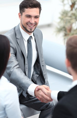 Sticker - handshake business partners in the lobby of the office.