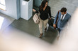© Jacob Lund - Business people arriving at hotel with luggage