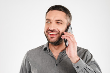 Canvas Print - Handsome businessman talking by mobile phone.