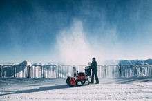 MAYRHOFEN, AUSTRIA - FEBRUARY 19, 2018: Man Working With Snow Blowing Machine In Mayrhofen Ski Area, Austria
