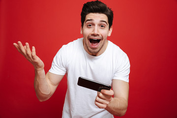 Poster - Portrait of a cheerful young man in white t-shirt