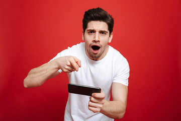 Poster - Portrait of a surprised young man in white t-shirt