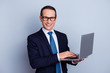 © deagreez - Leadership people social networking meeting global shopping person remote work concept. Portrait of smart exited cheerful satisfied financier using netbook isolated on gray background