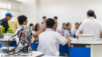 Wall Mural - robotic lab class with school students blur background learning in group having study workshop in sc