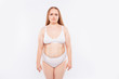 © deagreez - Young woman stands in underwear and frowns