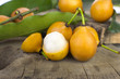 Open Bolivian exotic fruit called Achachairu in wood background